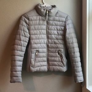 Light gray puffer coat with gold detailing.